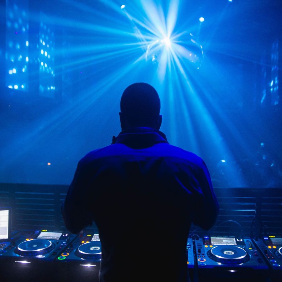DJ mixing, blue starburst stage lighting